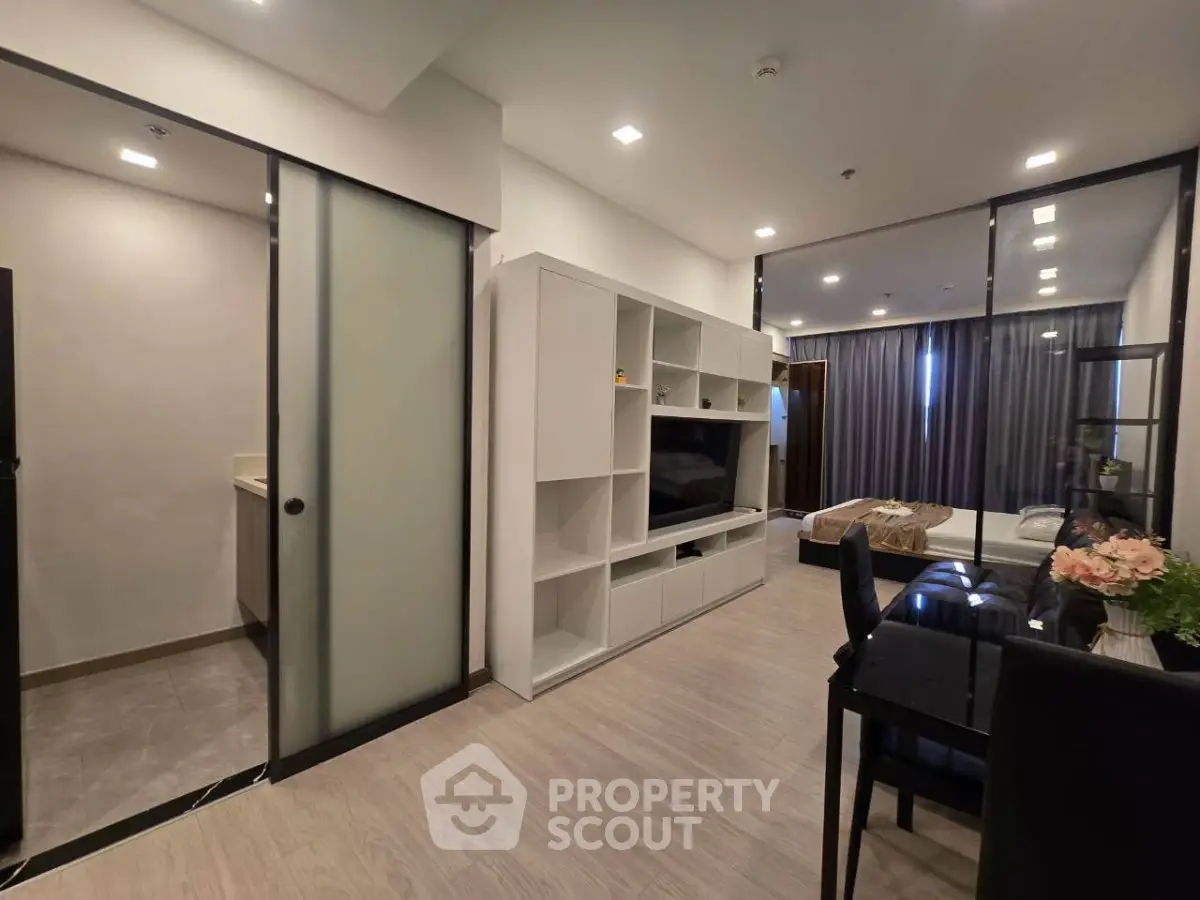 Modern open-plan living room with sleek furniture and dining area