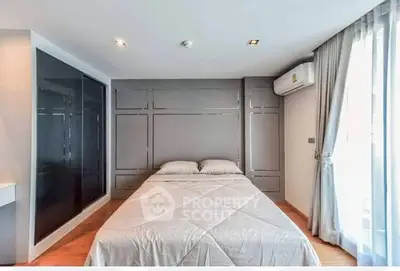 Modern bedroom with sleek design and ample natural light