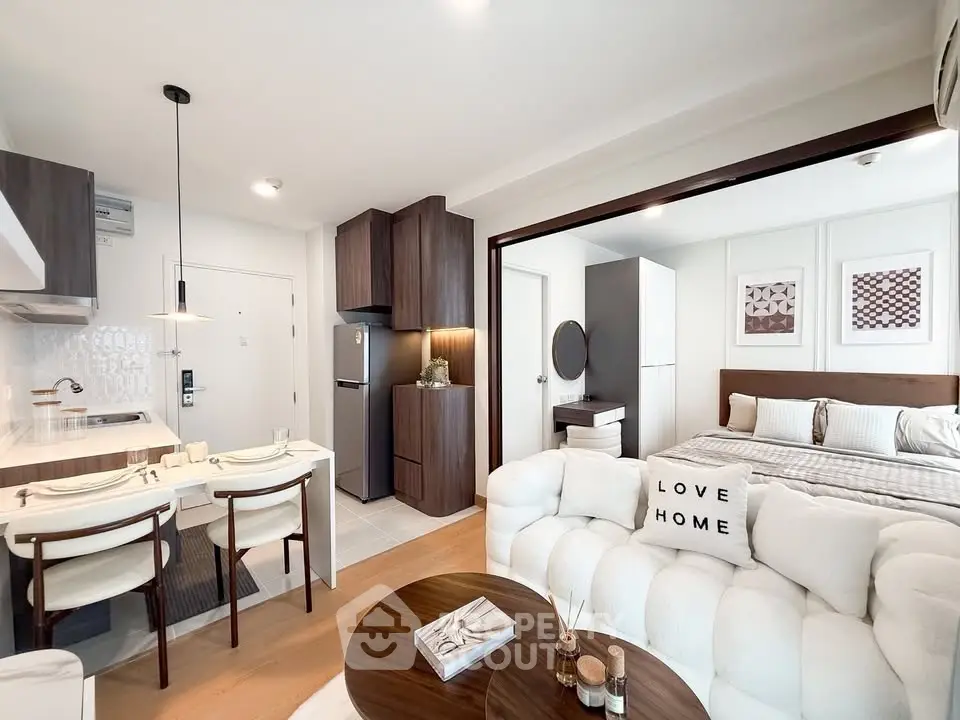 Modern open-plan living room and bedroom with stylish decor and cozy ambiance.