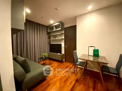 Modern living room with sleek furniture and wooden flooring in a cozy apartment.