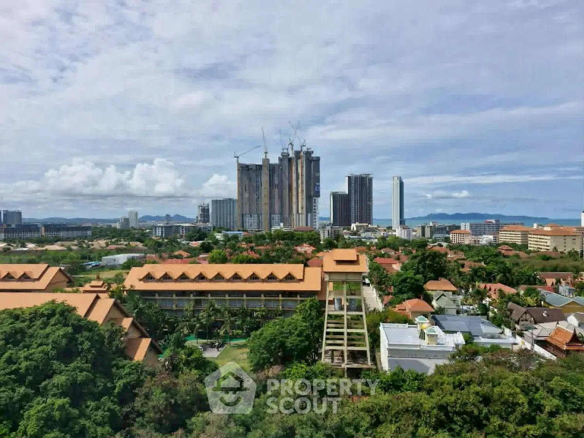 Stunning aerial view of urban skyline with high-rise buildings and lush greenery, perfect for real estate investment.