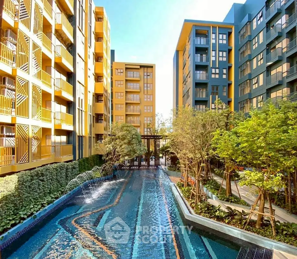 Stunning modern apartment complex with vibrant colors and inviting pool area.