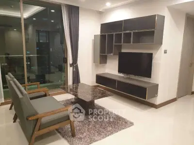 Modern living room with sleek furniture and large window offering city view.