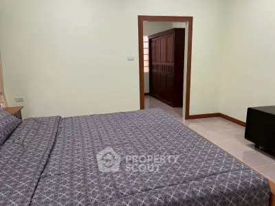 Spacious bedroom with modern decor and ample storage space