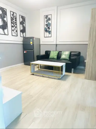 Modern living room with stylish decor and sleek furniture, featuring a comfortable sofa and elegant coffee table.