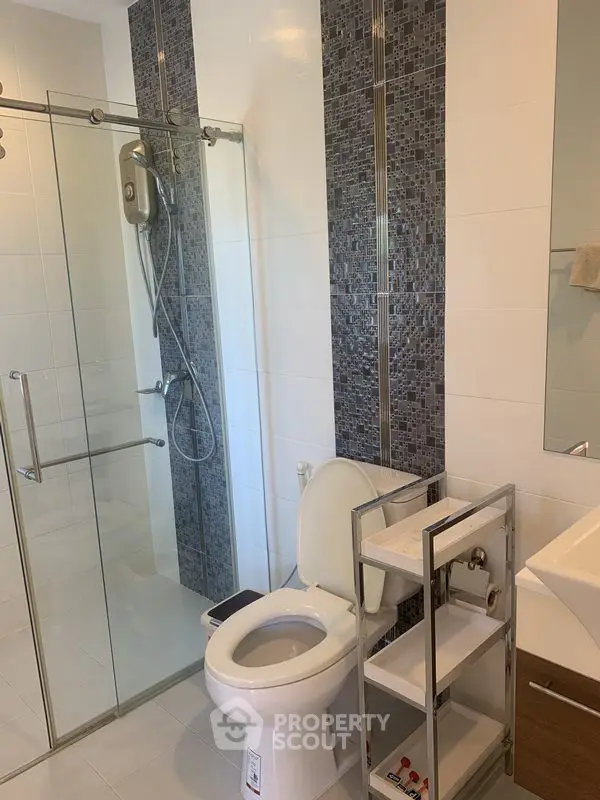 Modern bathroom with glass shower and sleek tile accents