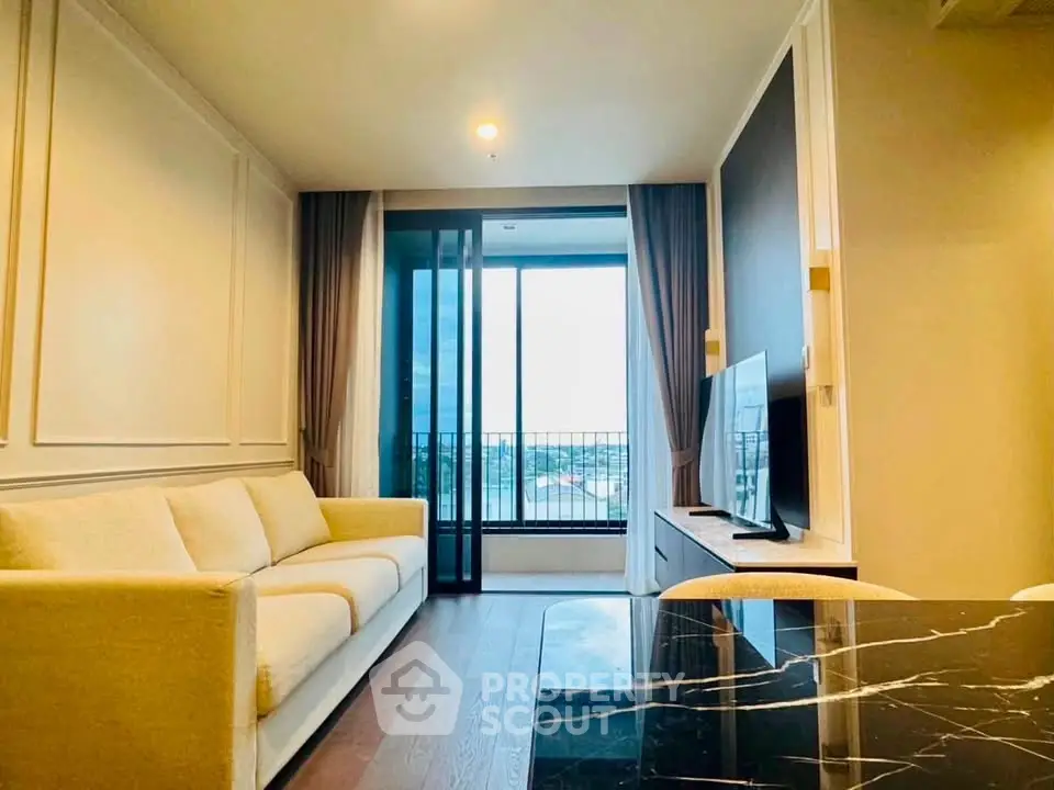 Modern living room with elegant decor and large window offering a stunning view.