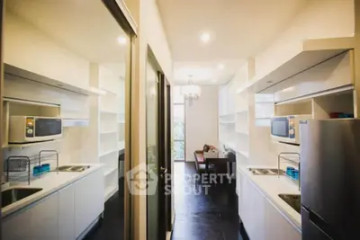 Modern kitchen with sleek white cabinetry and built-in appliances in a stylish apartment.