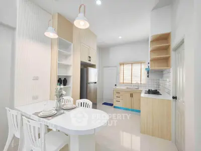 Modern kitchen with open layout, sleek cabinetry, and stylish lighting in a bright, airy space.
