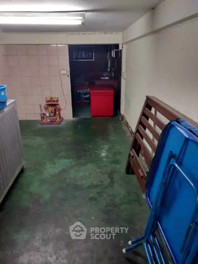 Basement storage area with folding chairs and a small shrine, ideal for extra space.