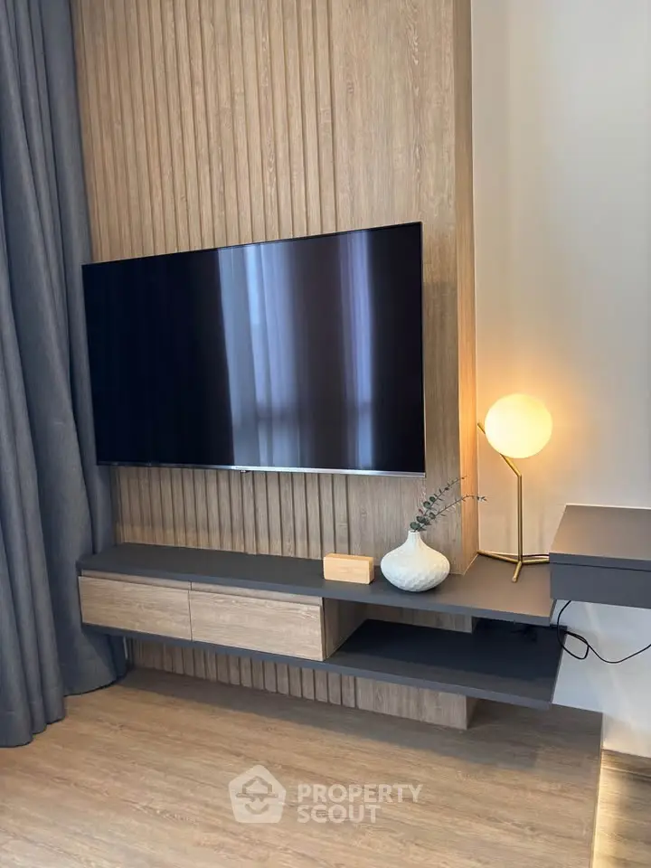 Modern living room with sleek TV setup and stylish lighting