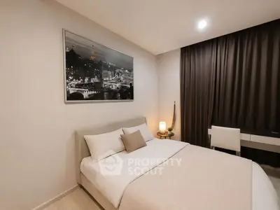 Elegant bedroom with modern decor and cozy ambiance, featuring a stylish bed and chic wall art.