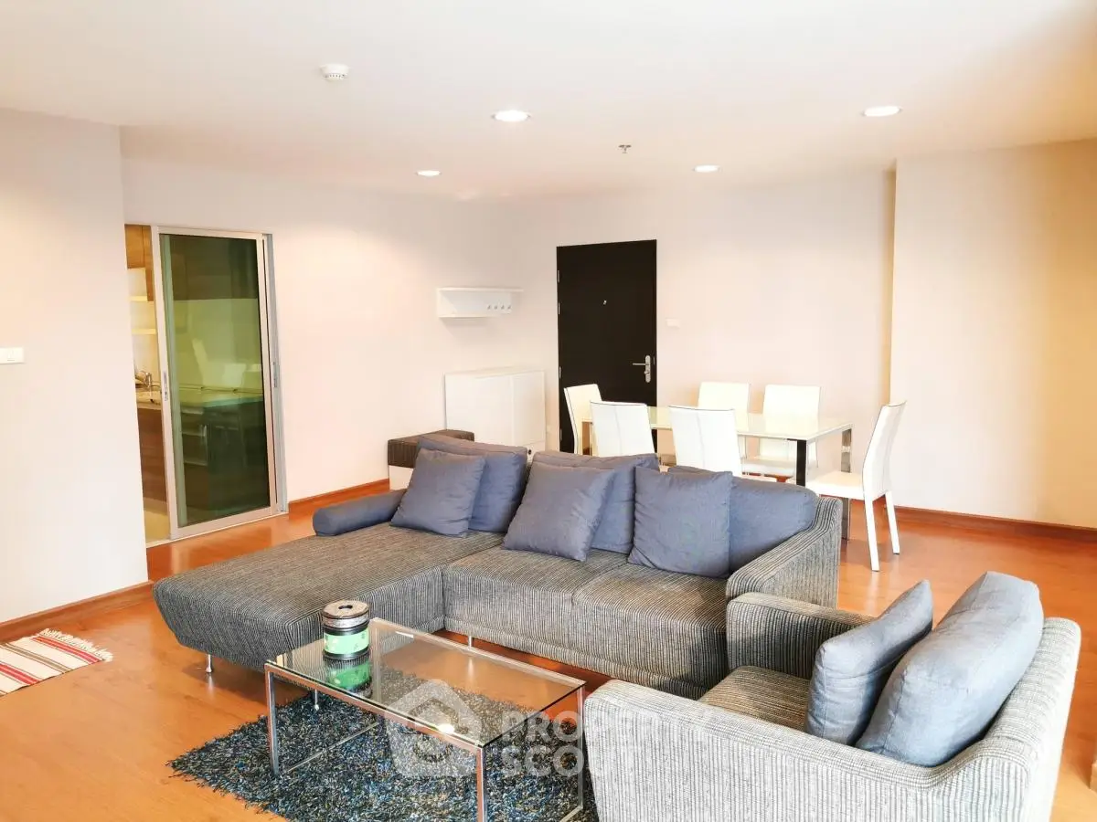 Spacious modern living room with stylish furniture and dining area, perfect for entertaining.