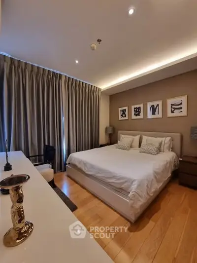 Luxurious bedroom with elegant decor and ambient lighting, featuring a comfortable bed and stylish furnishings.