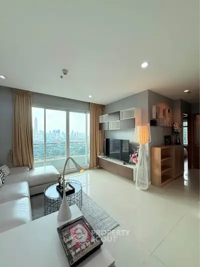 Spacious modern living room with city view, elegant decor, and ample natural light.