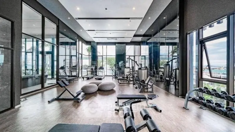 Luxurious modern gym with state-of-the-art equipment and panoramic windows offering stunning views.