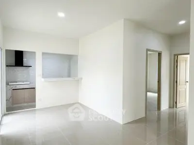 Spacious modern apartment with open layout and sleek kitchen design.