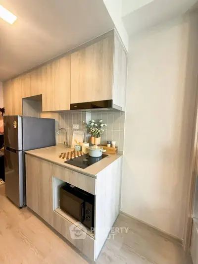 Modern kitchen with sleek cabinetry and built-in appliances in a stylish apartment.