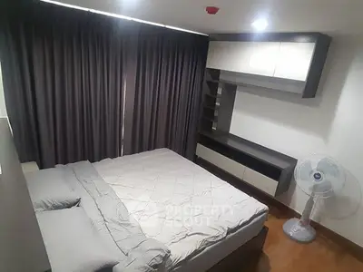 Modern bedroom with sleek furniture and cozy ambiance, featuring a comfortable bed and stylish storage solutions.