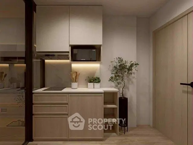 Modern compact kitchen with sleek cabinetry and integrated appliances in a stylish apartment.