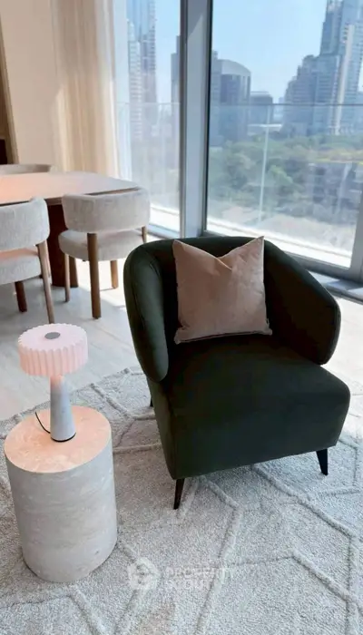 Stylish living room with modern armchair and city view, perfect for urban living.