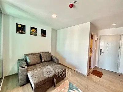 Modern living room with cozy gray sofa and stylish wall art, perfect for relaxation.