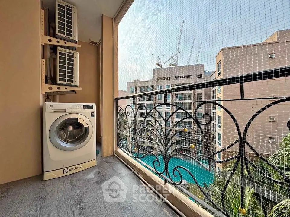 Charming balcony with washing machine and city view, perfect for urban living.