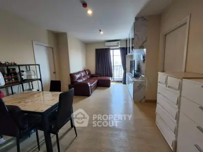 Spacious living room with modern decor and balcony access