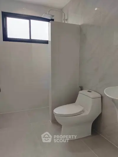 Modern bathroom with sleek design and natural light from window