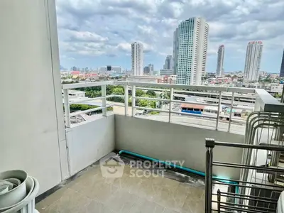 Spacious balcony with stunning city skyline view, perfect for relaxation and enjoying urban living.