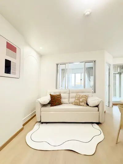 Modern living room with stylish decor and cozy seating in a bright apartment.