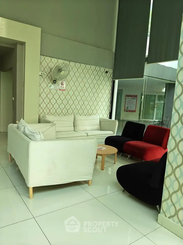 Modern lobby with stylish seating and contemporary decor in a residential building.