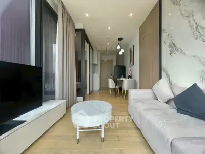 Modern living room with elegant decor and open layout, featuring a cozy sofa and stylish coffee table.