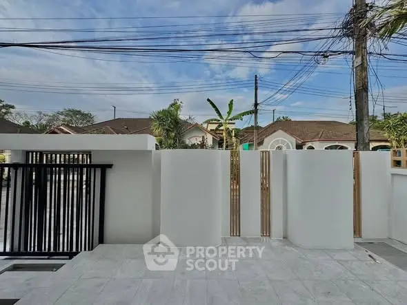 Modern exterior with sleek white walls and open view of suburban neighborhood.