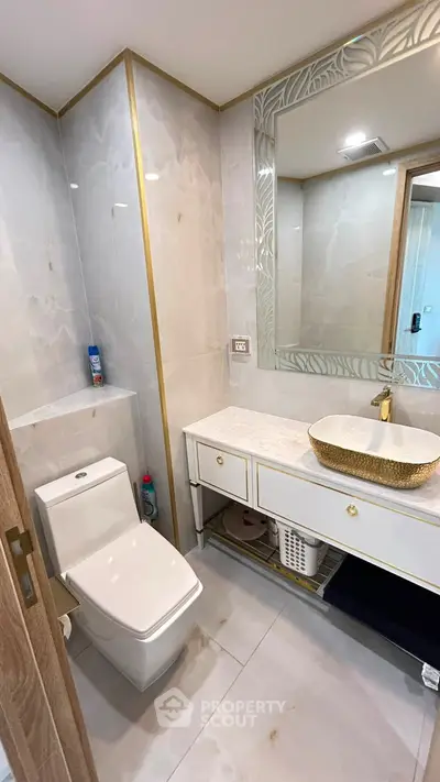 Luxurious bathroom with elegant marble tiles and modern fixtures in a stylish apartment.