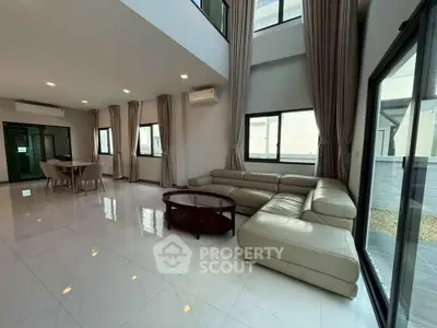 Spacious modern living room with high ceilings and elegant furnishings