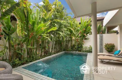 Luxurious private pool surrounded by lush tropical greenery in a serene outdoor setting.