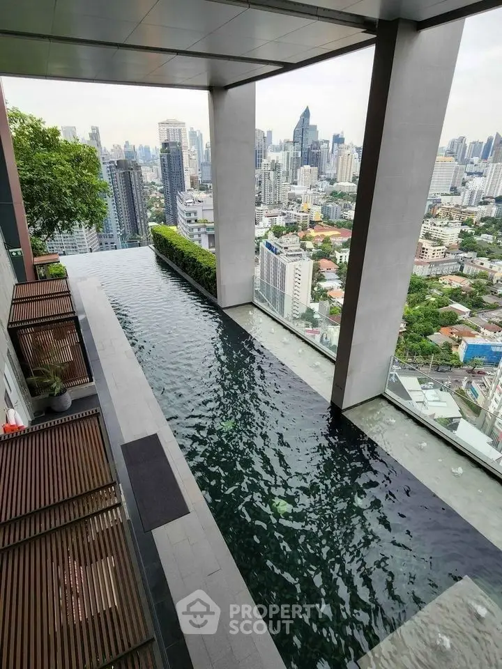 Luxurious rooftop pool with stunning city skyline view in modern high-rise building.