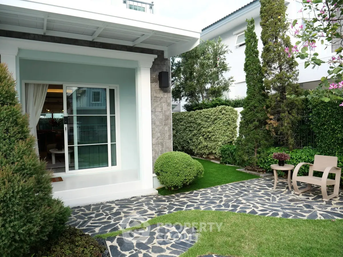 Charming garden with stone pathway and cozy seating area in modern home exterior