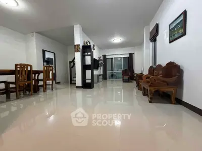 Spacious living room with elegant wooden furniture and glossy tile flooring