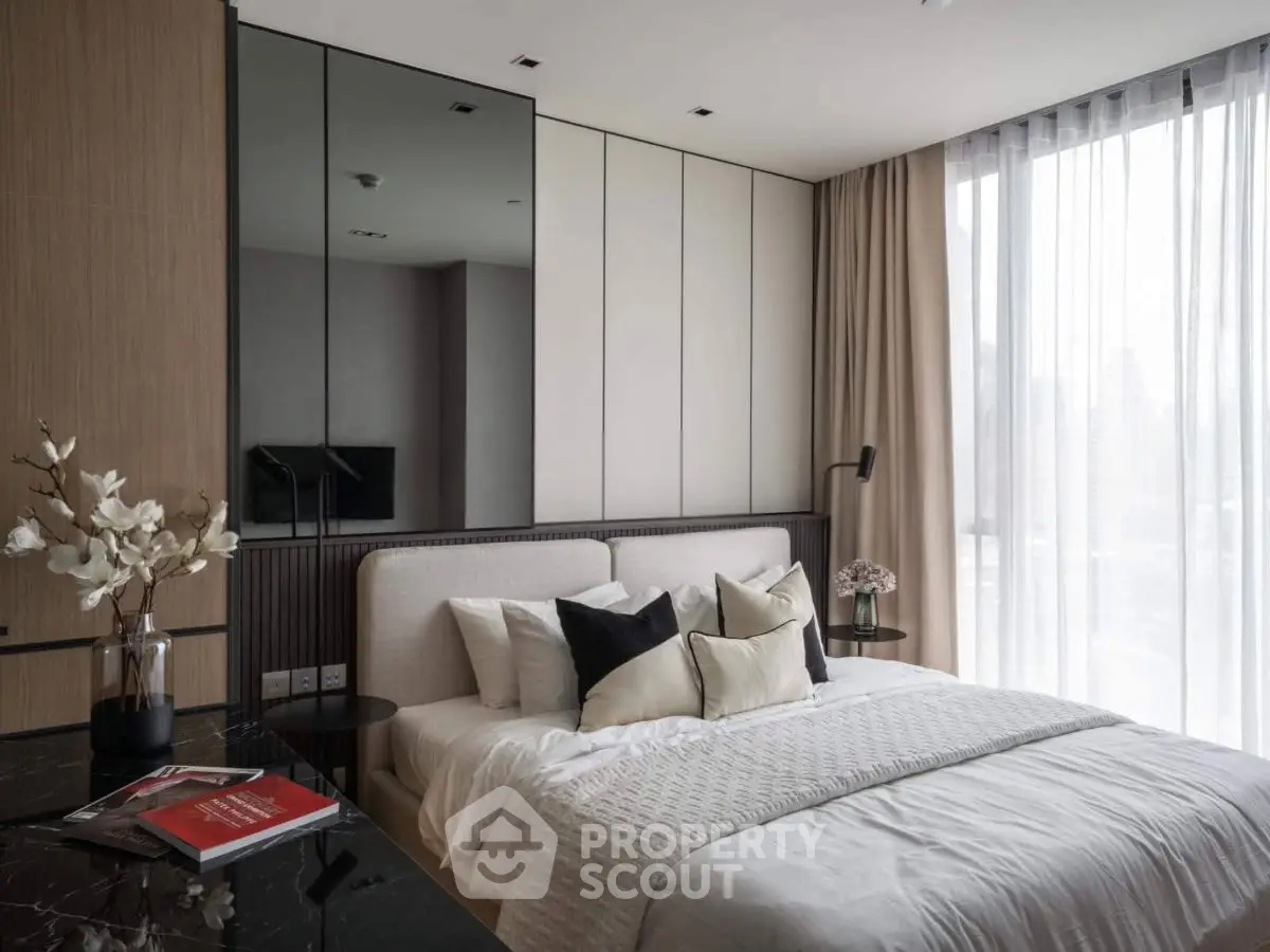 Modern bedroom with elegant decor and large window for natural light