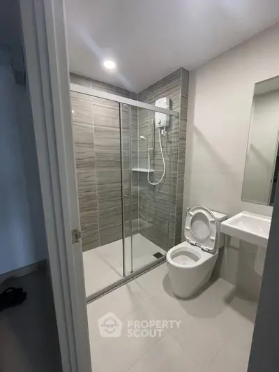 Modern bathroom with glass shower enclosure and sleek fixtures