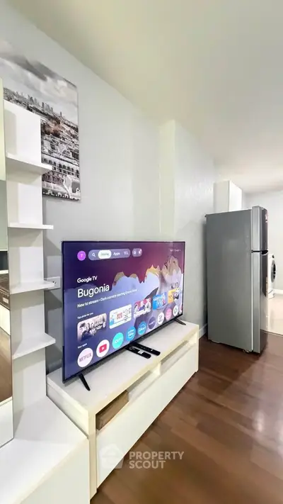 Modern living room with smart TV and sleek appliances in a stylish apartment.