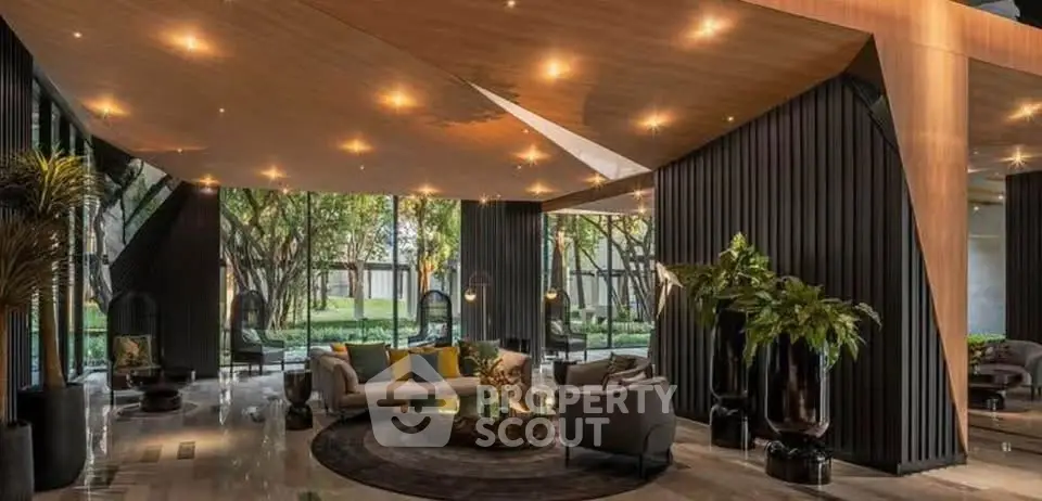 Luxurious modern living room with elegant decor and large windows overlooking lush greenery.