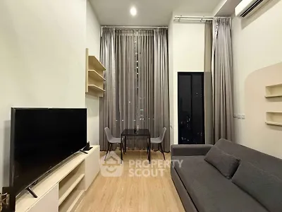 Modern living room with high ceilings, elegant curtains, and stylish furniture in a cozy apartment.