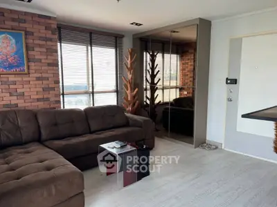 Modern living room with brick accent wall and plush brown sofa