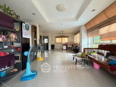 Spacious living room with modern decor and ample natural light