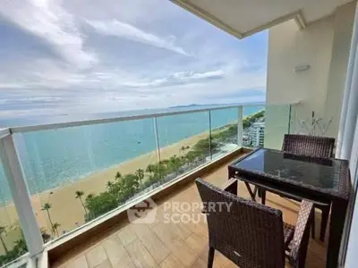 Stunning beachfront balcony with panoramic ocean view and elegant outdoor seating.