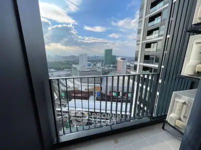 Stunning city view from modern high-rise balcony with sleek railing.