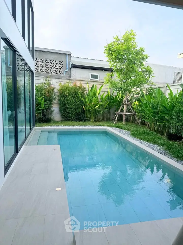 Luxurious private pool with lush garden in modern home setting